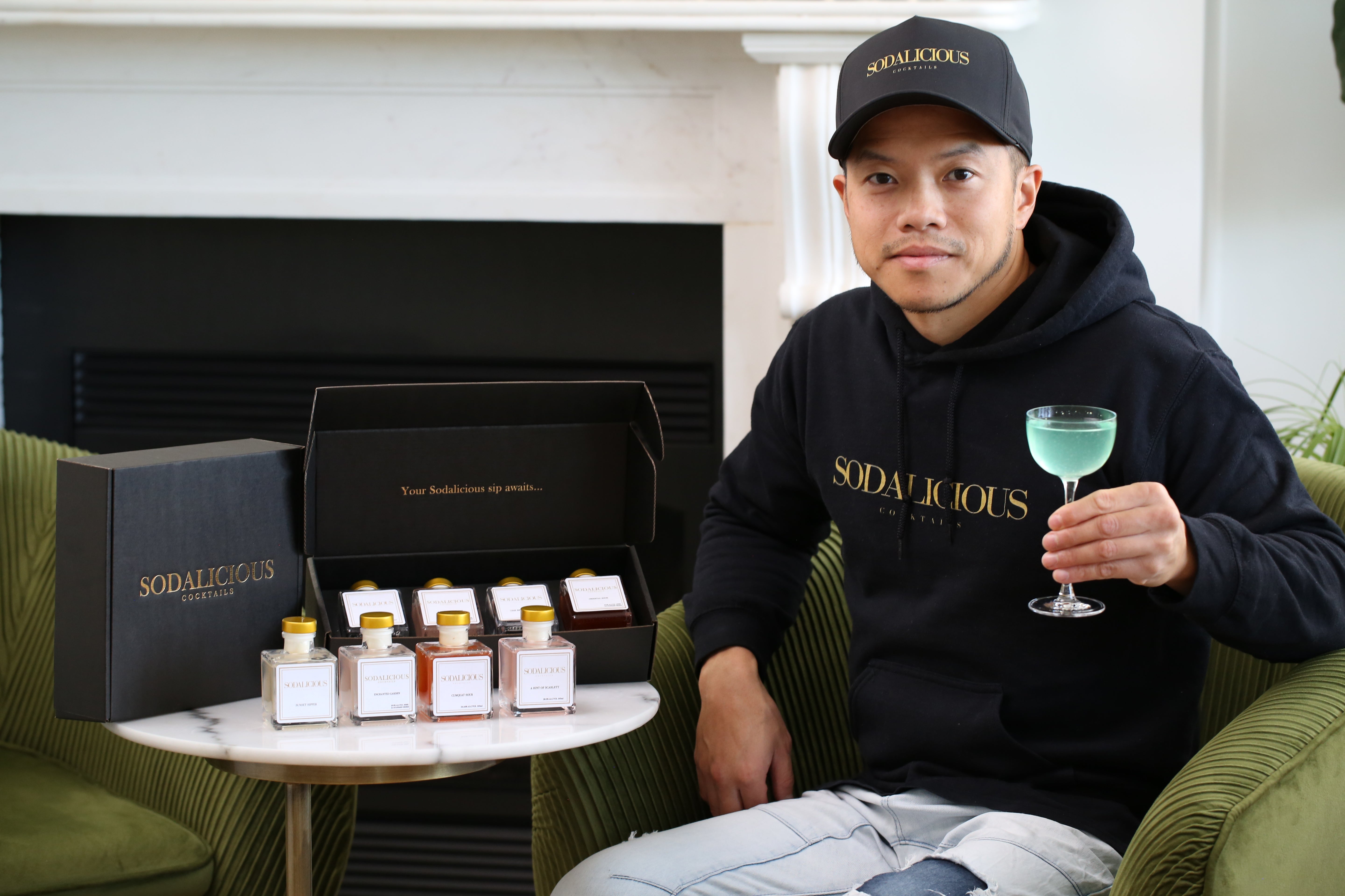 Founder of Sodalicious Cocktails holding a cocktail