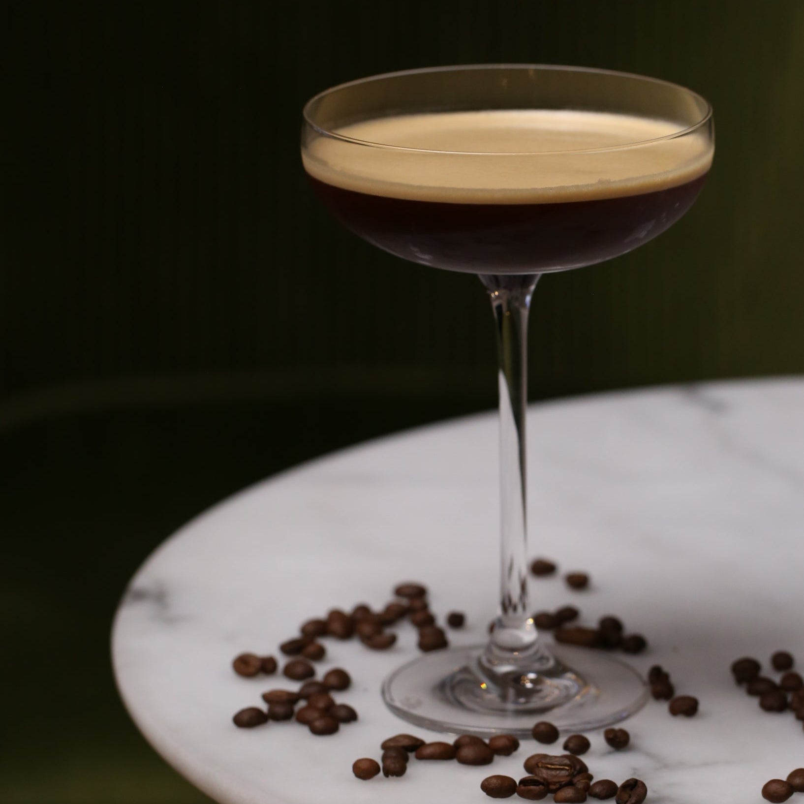 Cocktail in a glass with coffee beans on a marble surface - Ready to drink cocktails - tequila espresso martini